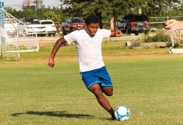 action shot of Daniel Bustos kicking a soccer ball