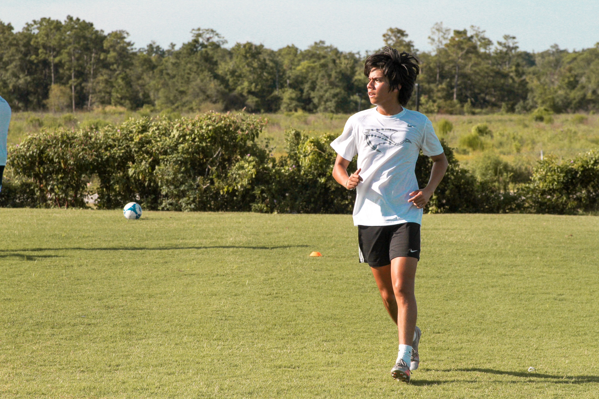 action shot of Alex Medina kicking a soccer ball